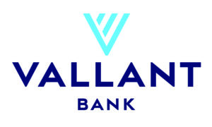Logo for Vallant Bank. A stylized V in light blue appears above the name VALLANT in bold, dark blue uppercase letters, with the word BANK below in smaller, spaced-out letters. White background.