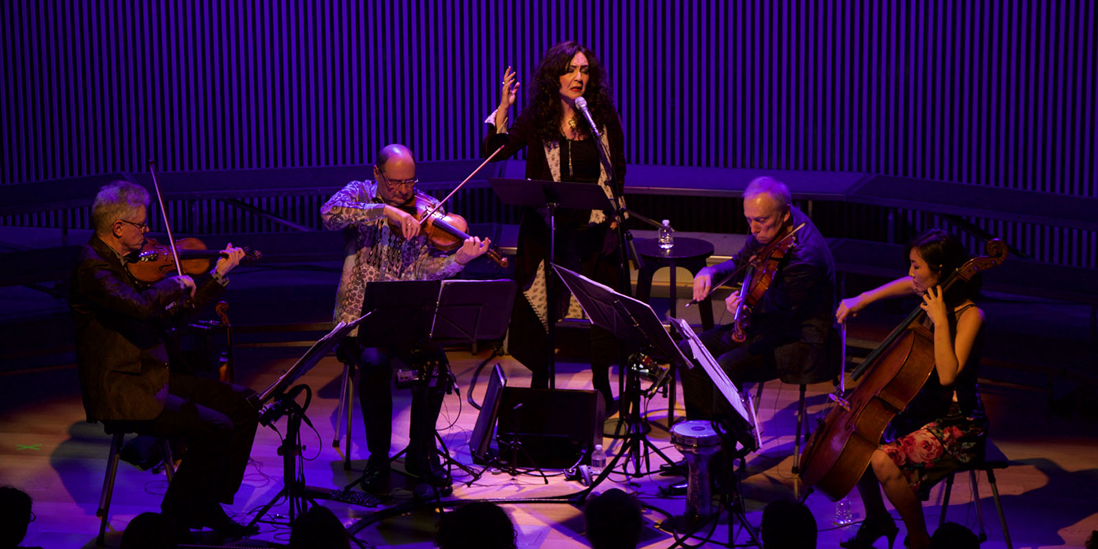 Kronos Quartet and Mahsa Vahdat performing on stage.