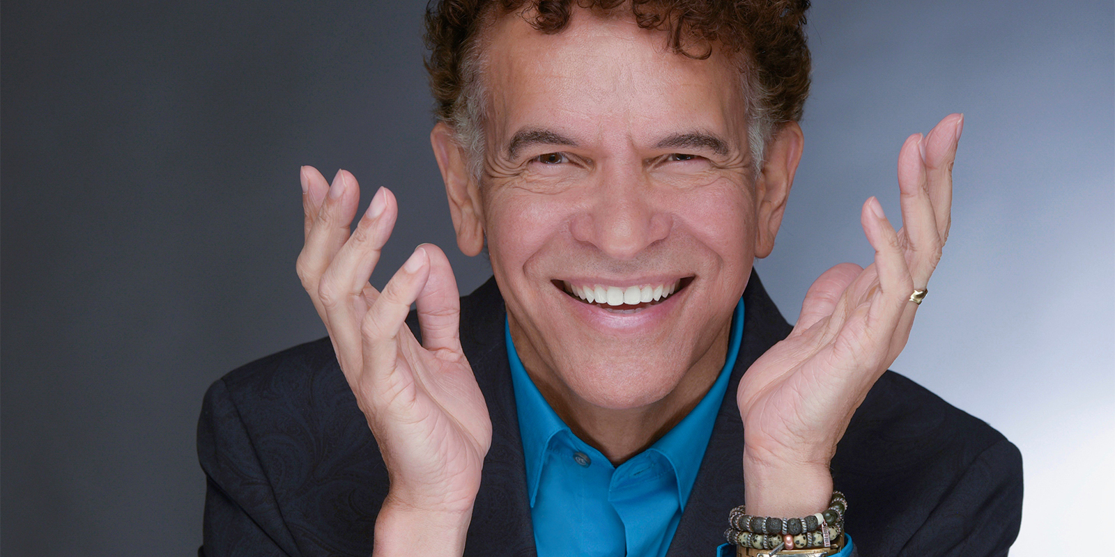 Brian Stokes Mitchell looking that viewer with a smile.