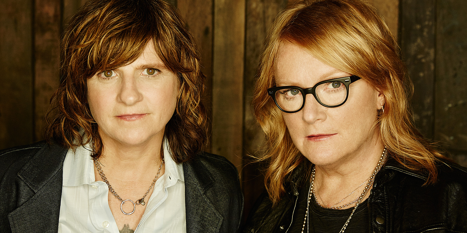 Amy Ray and Emily Saliers wear white and black clothing and look at the camera