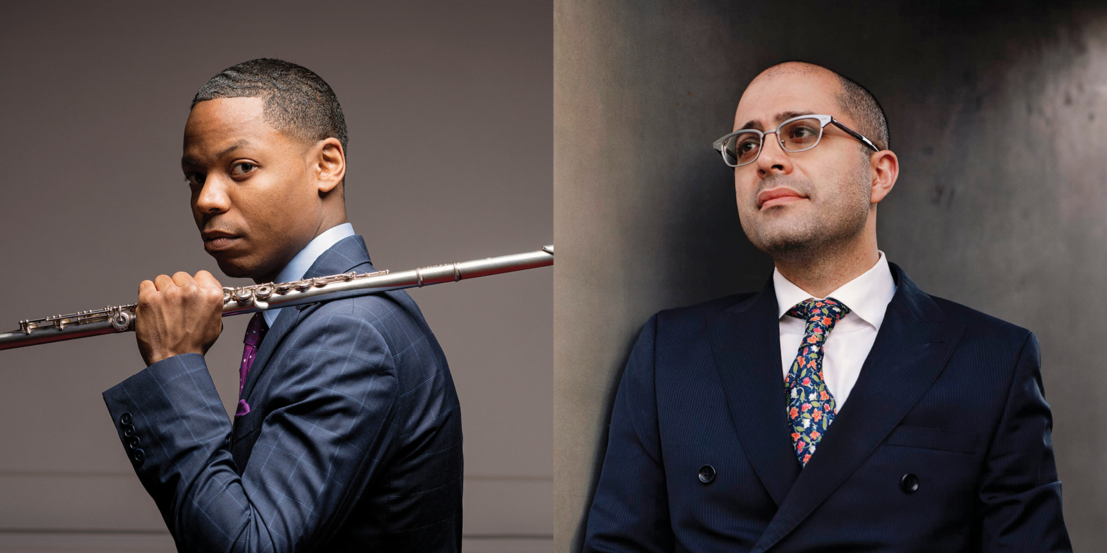 A man in a blue suit holds a flute on his shoulder. Another man in a dark suit and glasses looks off to the side.