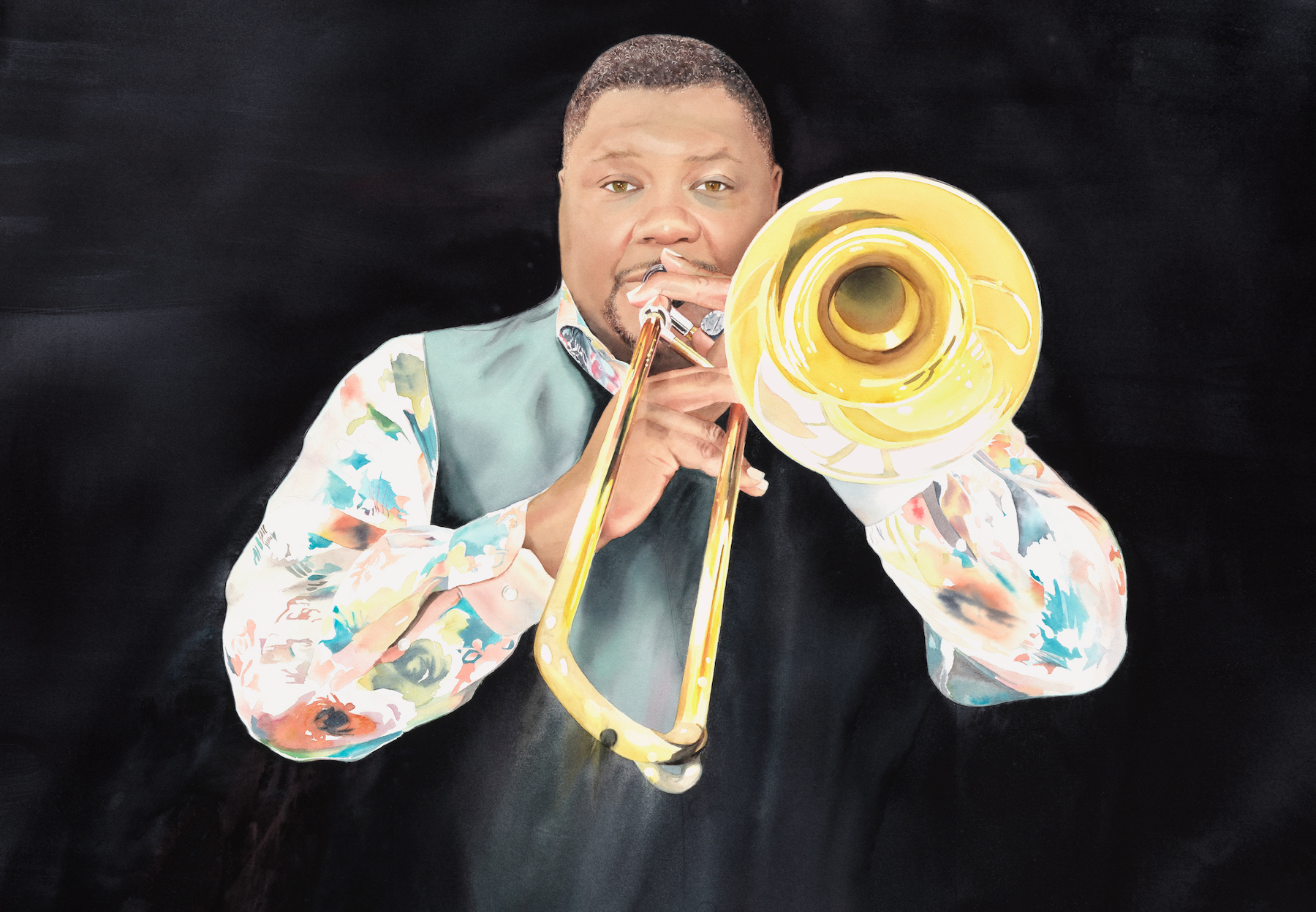 A man in a colorful floral shirt and dark vest plays a brass trombone against a solid black background, looking directly at the camera through the instrument’s bell.